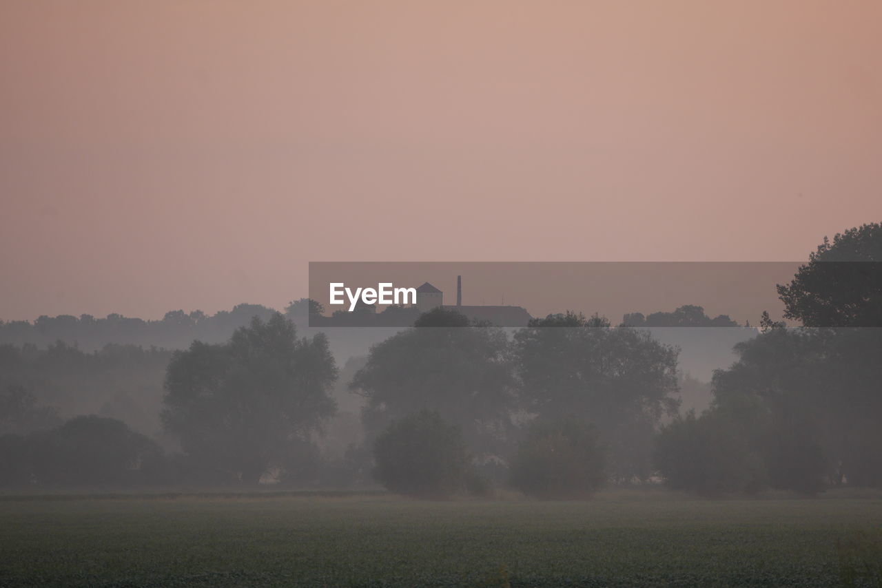 Scenic view of field against sky during sunset