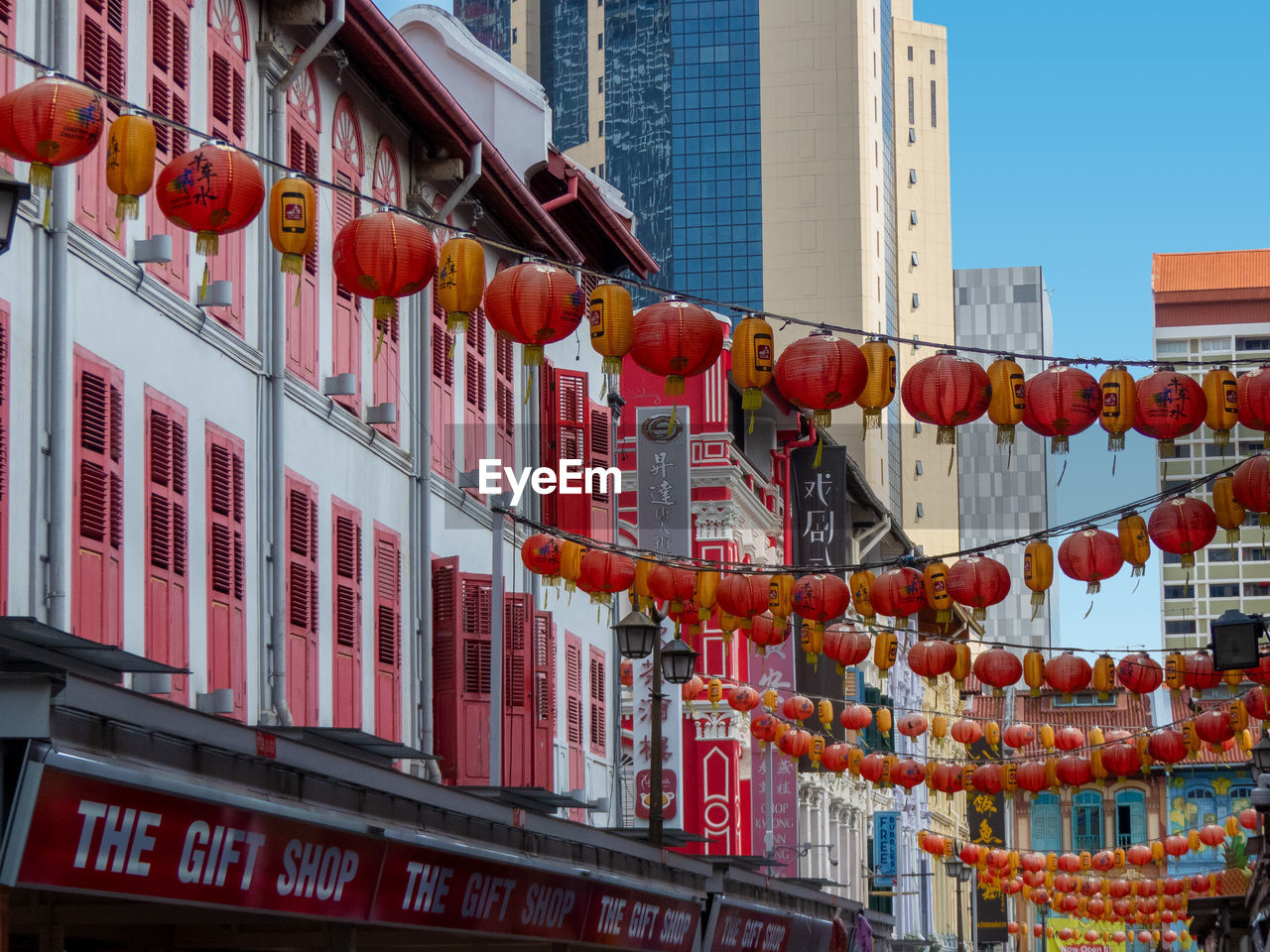 LOW ANGLE VIEW OF LANTERNS HANGING IN CITY