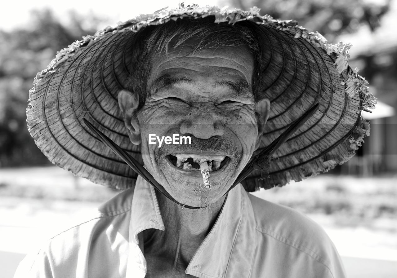 Portrait of smiling man smoking cigarette