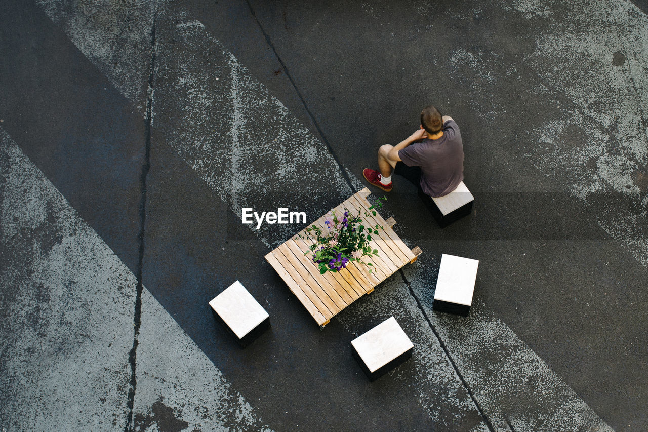 High angle view of man sitting on chair