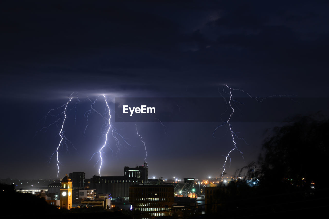 View of lightning over city at night