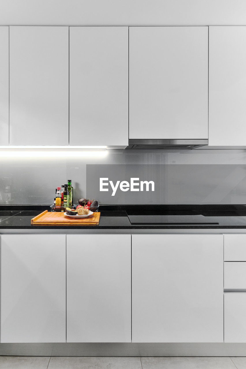 kitchen, domestic room, domestic kitchen, home, cabinetry, indoors, room, interior design, floor, furniture, home interior, kitchen counter, cupboard, lifestyles, household equipment, countertop, cabinet, food and drink, architecture, appliance, sink, no people, domestic life, flooring, stove, sideboard, shelf, built structure, tile, food, building, wall, home showcase interior