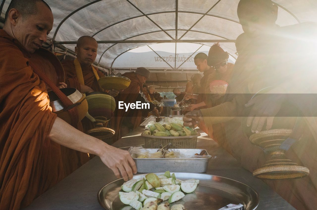 GROUP OF PEOPLE IN MARKET STALL