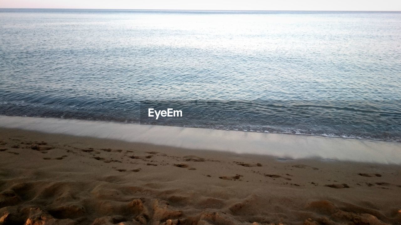 sea, beach, water, sand, nature, shore, horizon over water, tranquil scene, tranquility, beauty in nature, scenics, no people, outdoors, day, wave, sky
