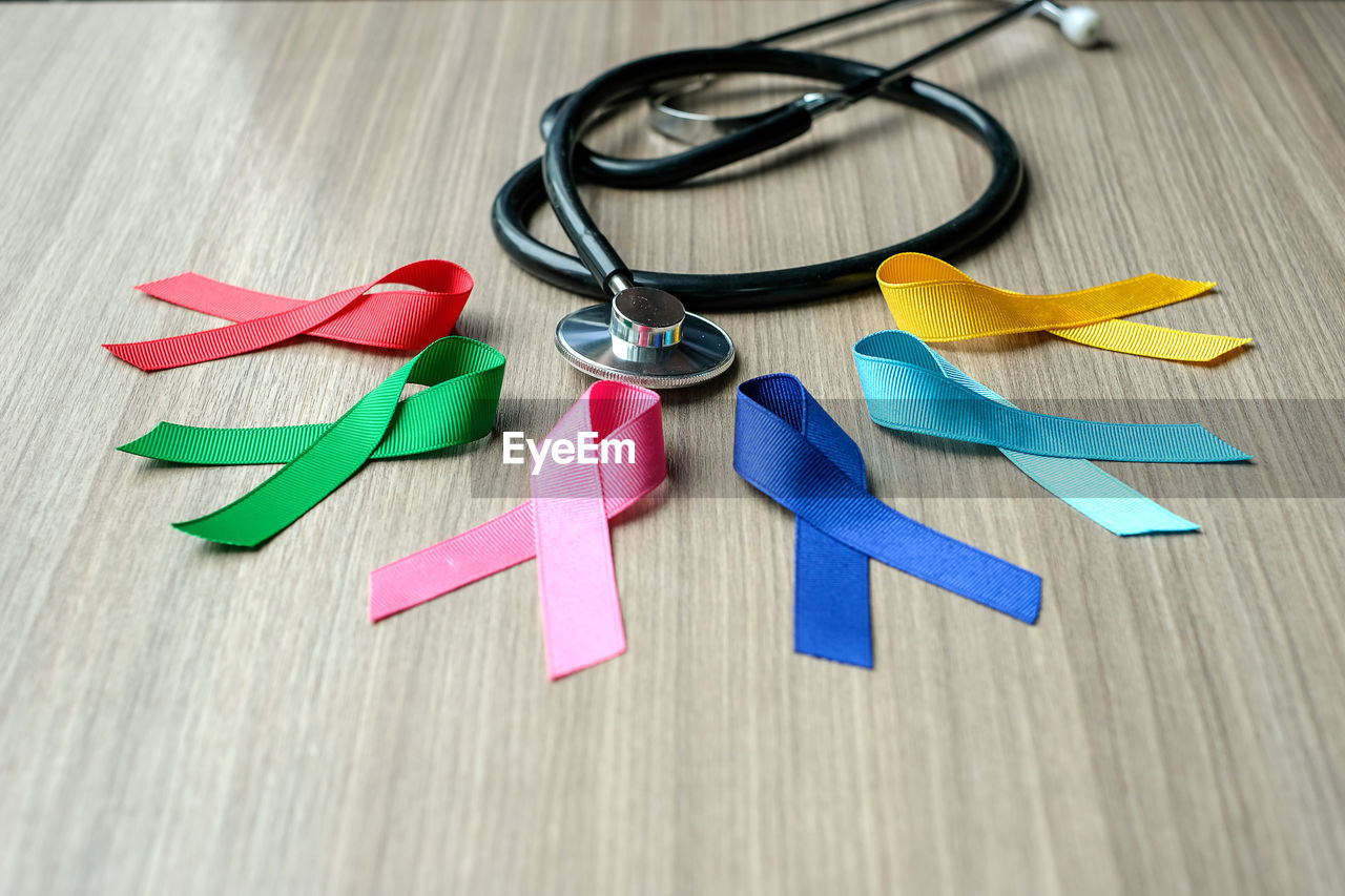 Multi colored ribbons with stethoscope on table