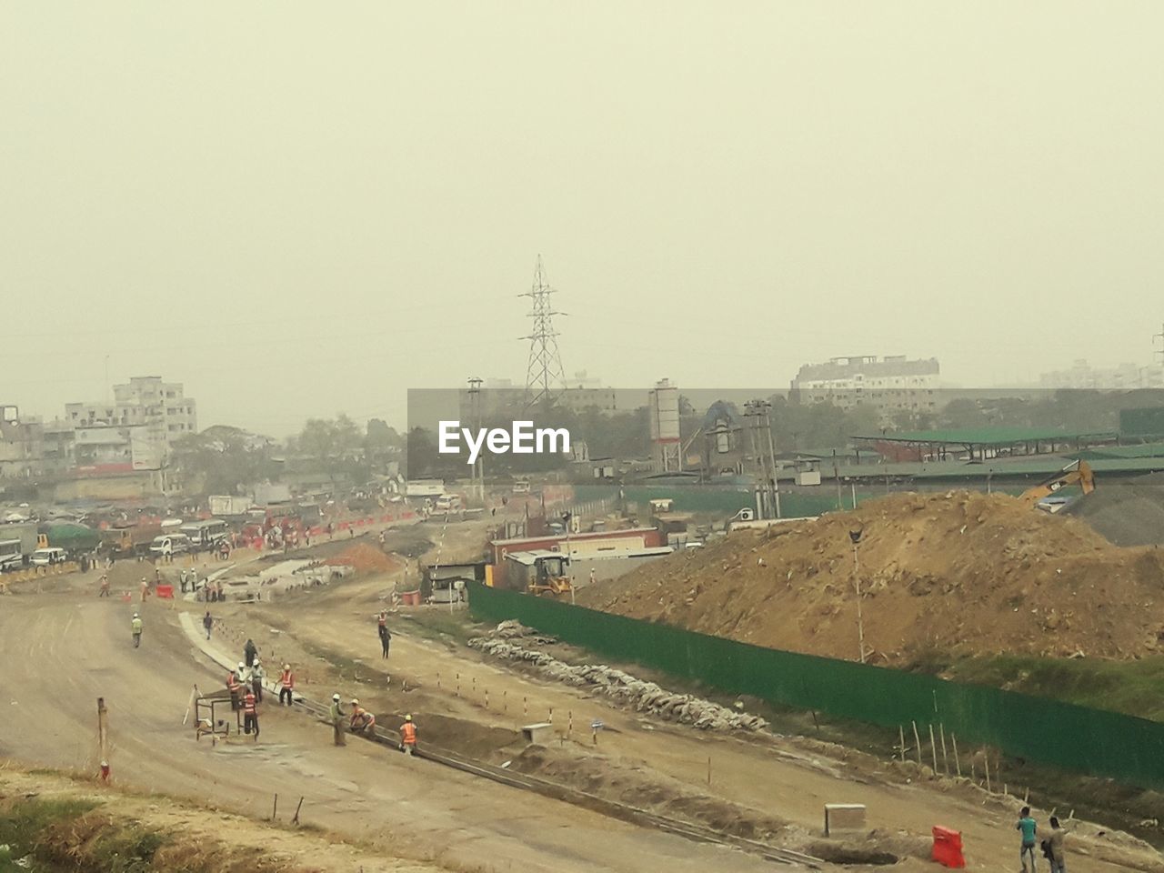 VEHICLES ON ROAD AGAINST CLEAR SKY IN CITY