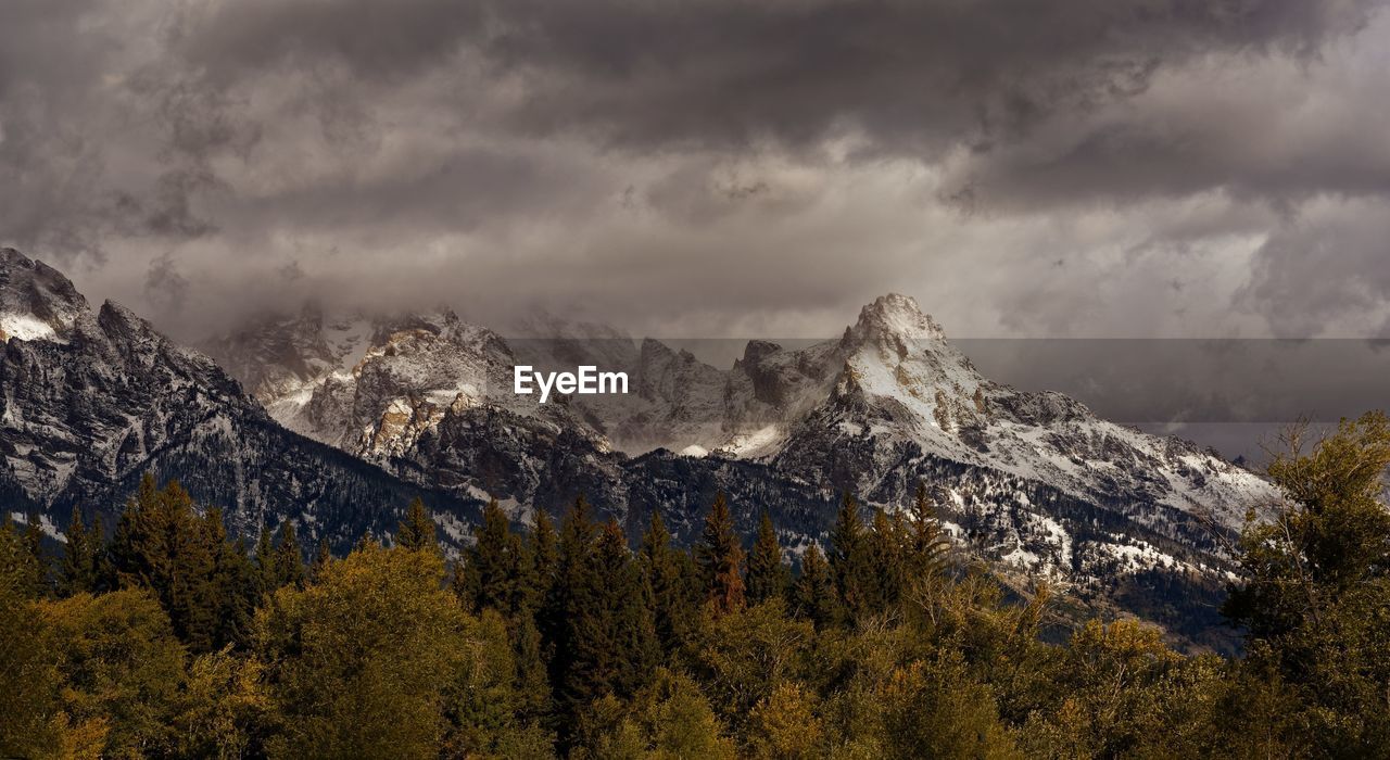 Scenic view of mountains against cloudy sky