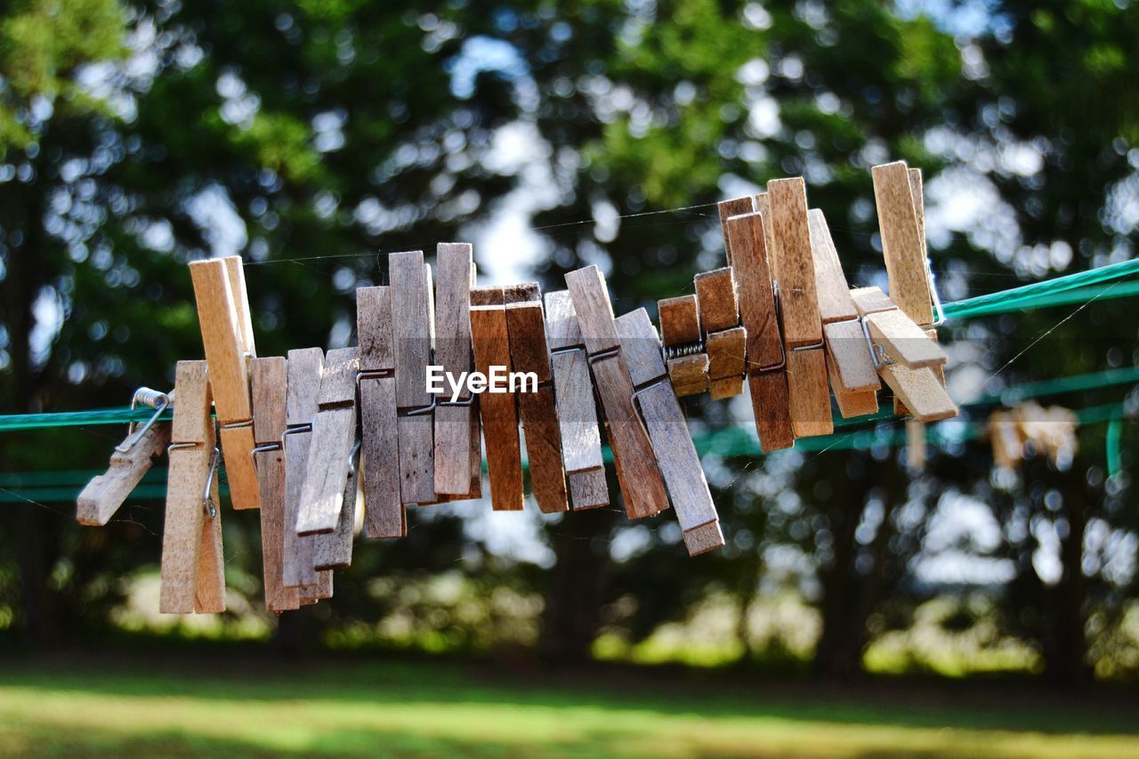 Close-up of clothespins hanging on clothesline