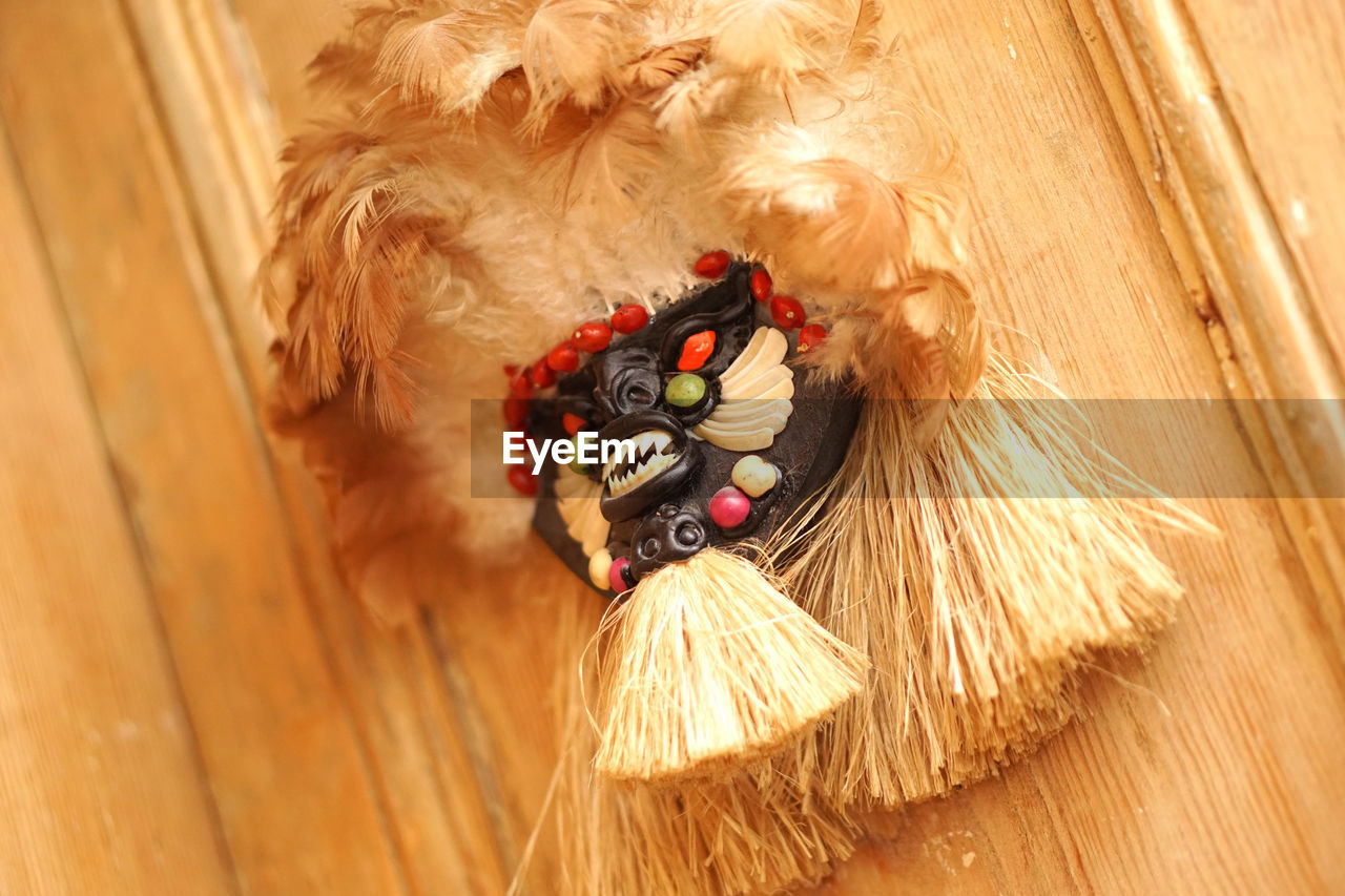 Close-up of mask hanging on wood