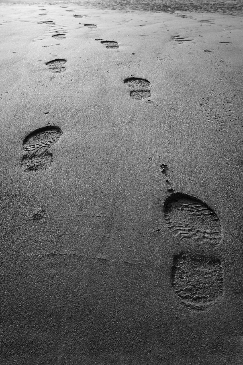 High angle view of shoeprints at beach