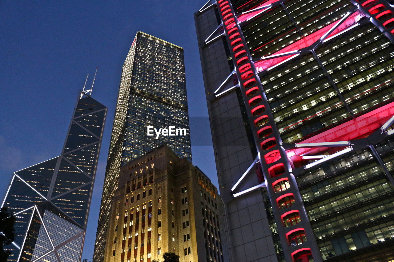 Low angle view of illuminated buildings against sky at dusk