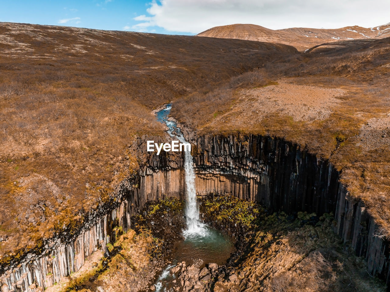 Aerial view of the svartifoss waterfall surrounded by basalt columns