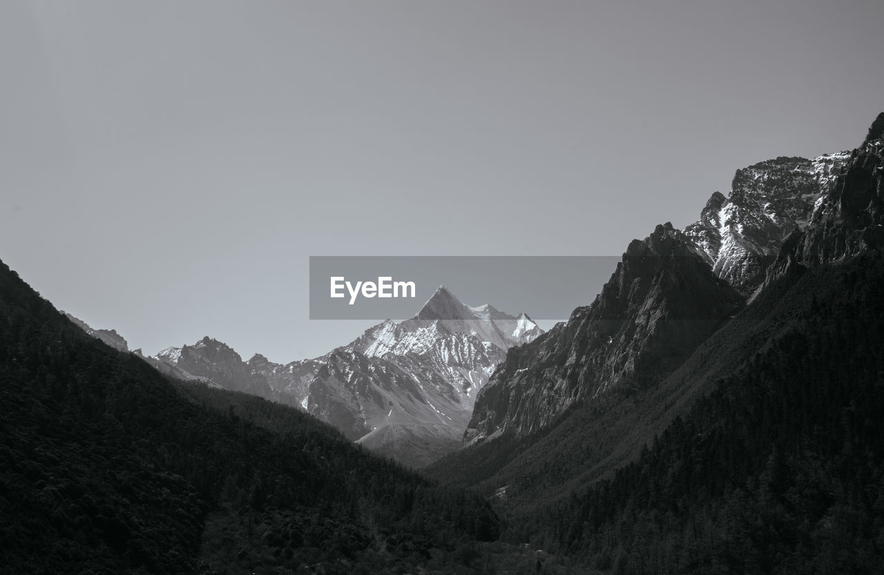 Scenic view of snowcapped mountains against clear sky