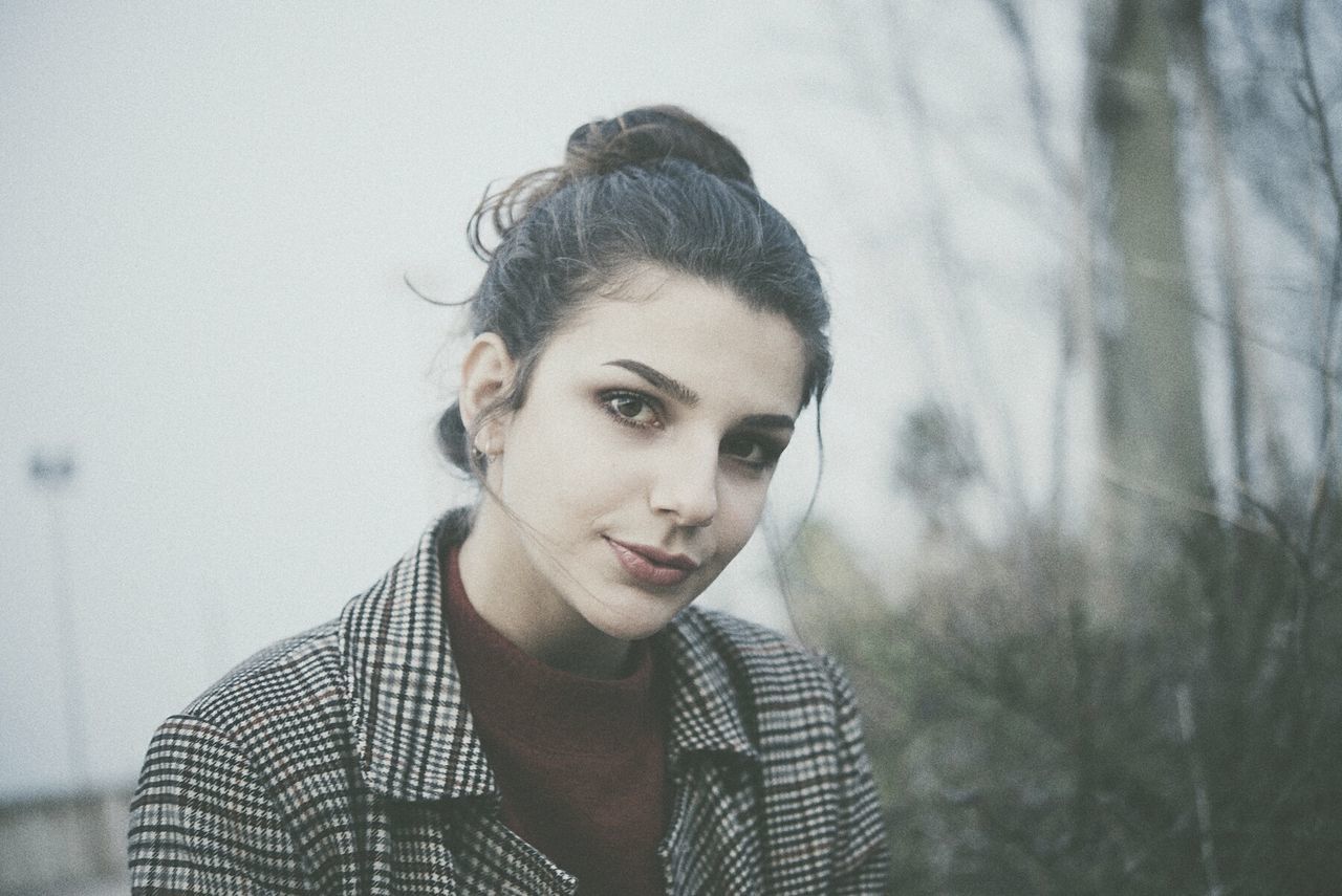 CLOSE-UP OF YOUNG WOMAN WITH EYES CLOSED