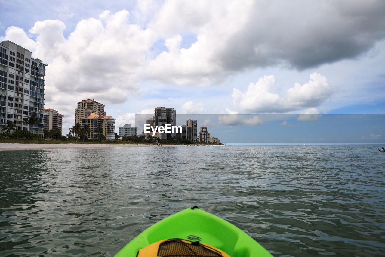 BUILDINGS BY SEA AGAINST SKY