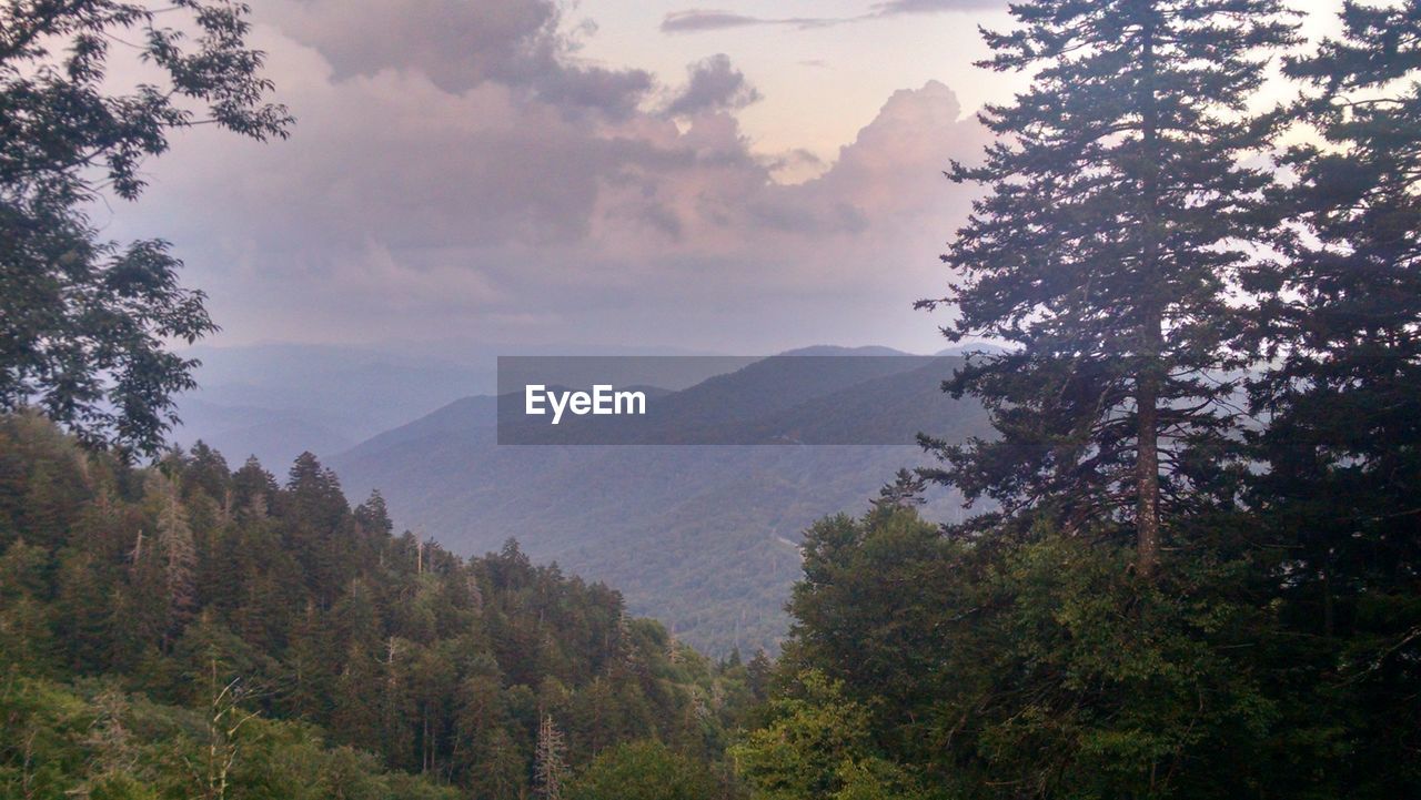 Scenic view of mountain against cloudy sky