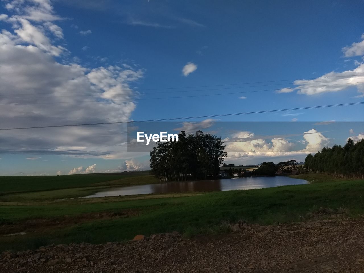 SCENIC VIEW OF GRASSY FIELD AGAINST SKY