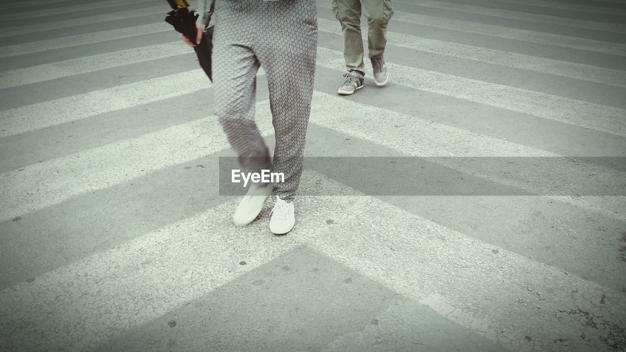 Low section of people walking on street