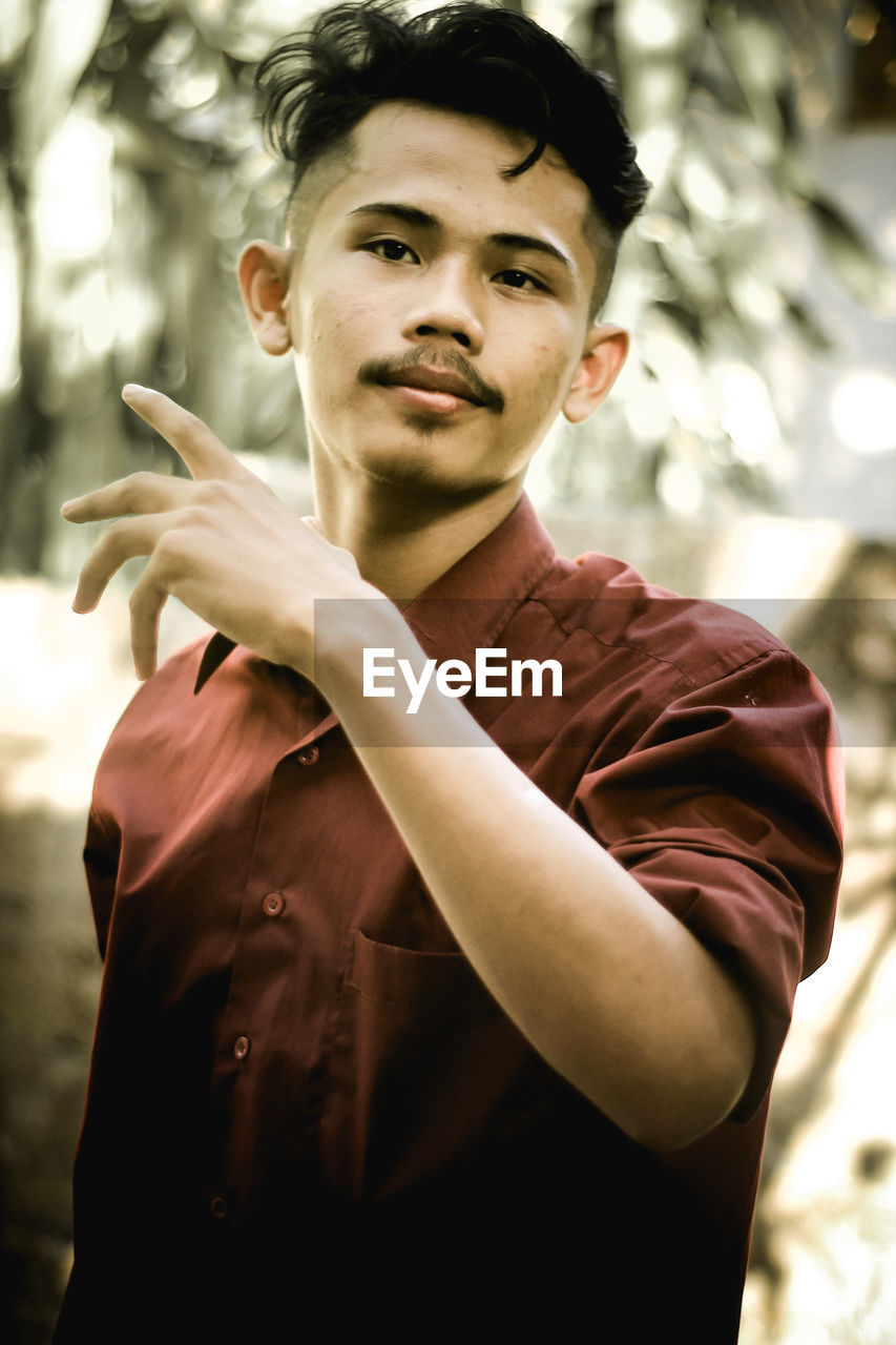 Portrait of young man standing outdoors