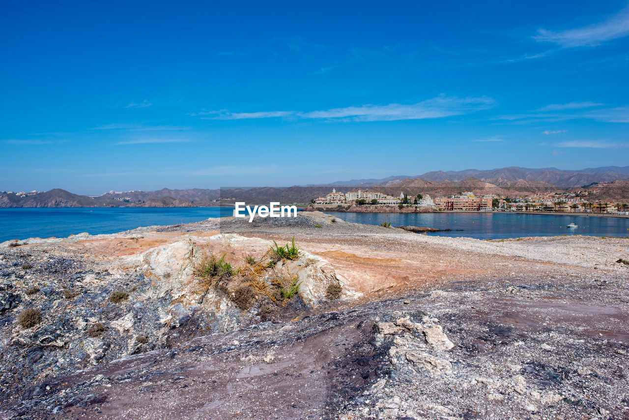 Scenic view of beach against blue sky