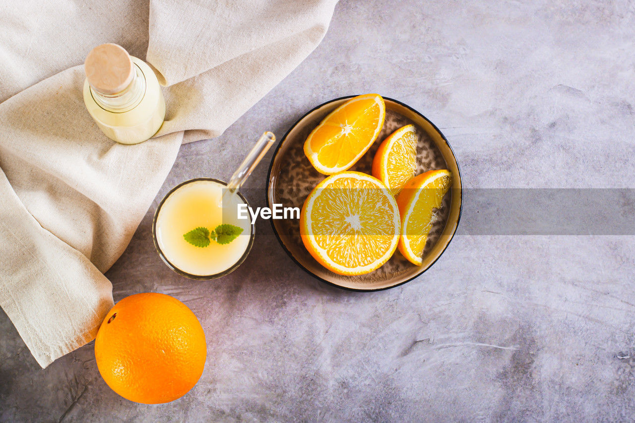 Vegetarian smoothie made from rice milk and orange in a glass on the table top view