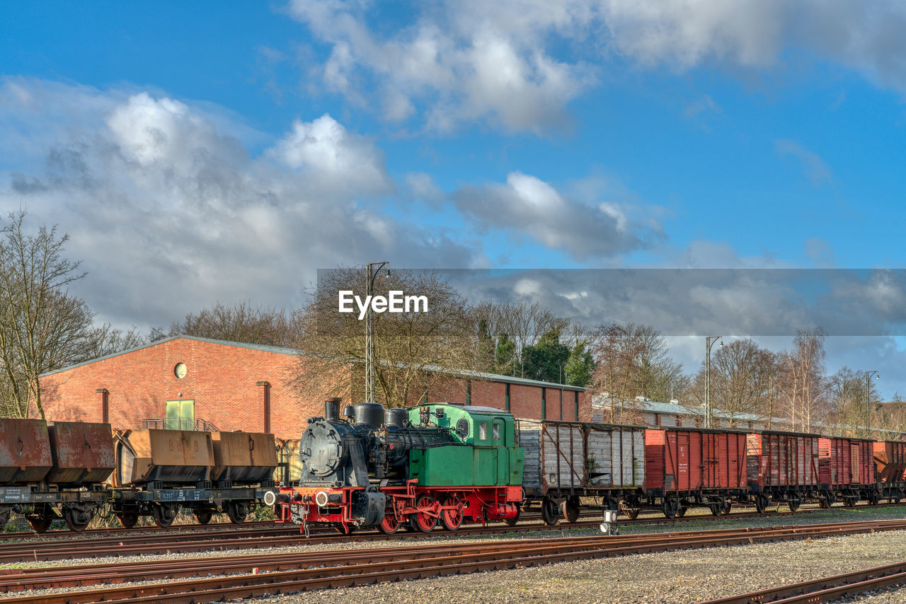 Train on railroad track against sky