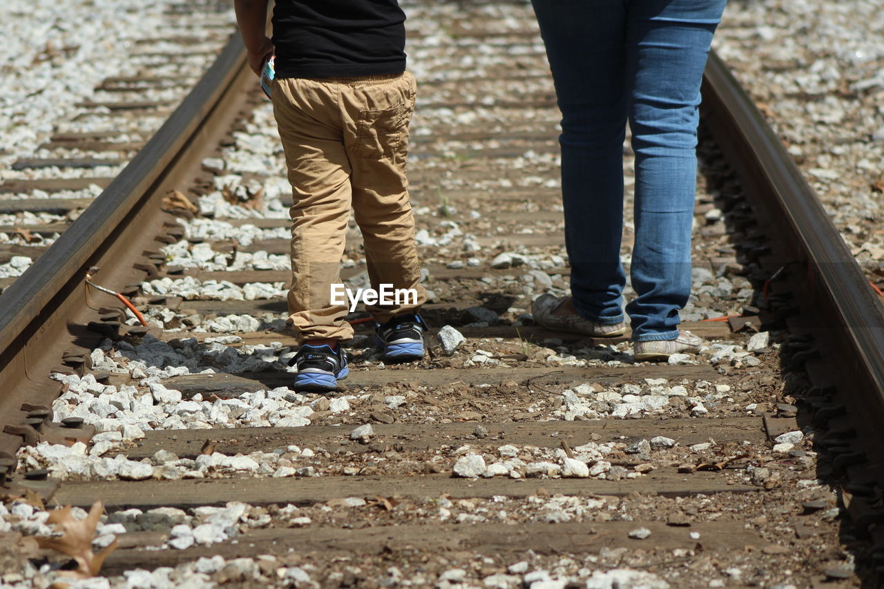 LOW SECTION OF PEOPLE ON RAILROAD TRACKS