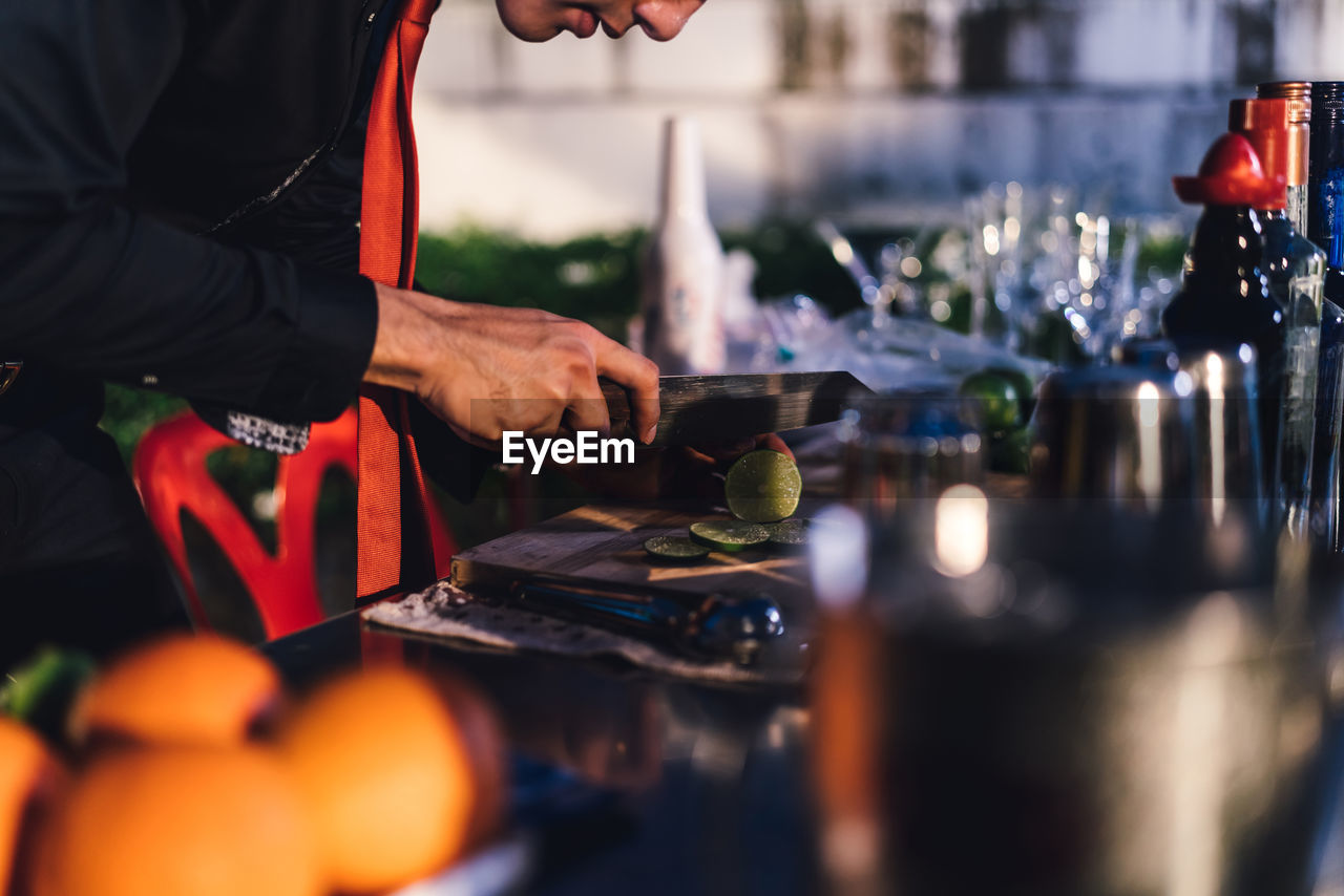 Young bartender working in party at night