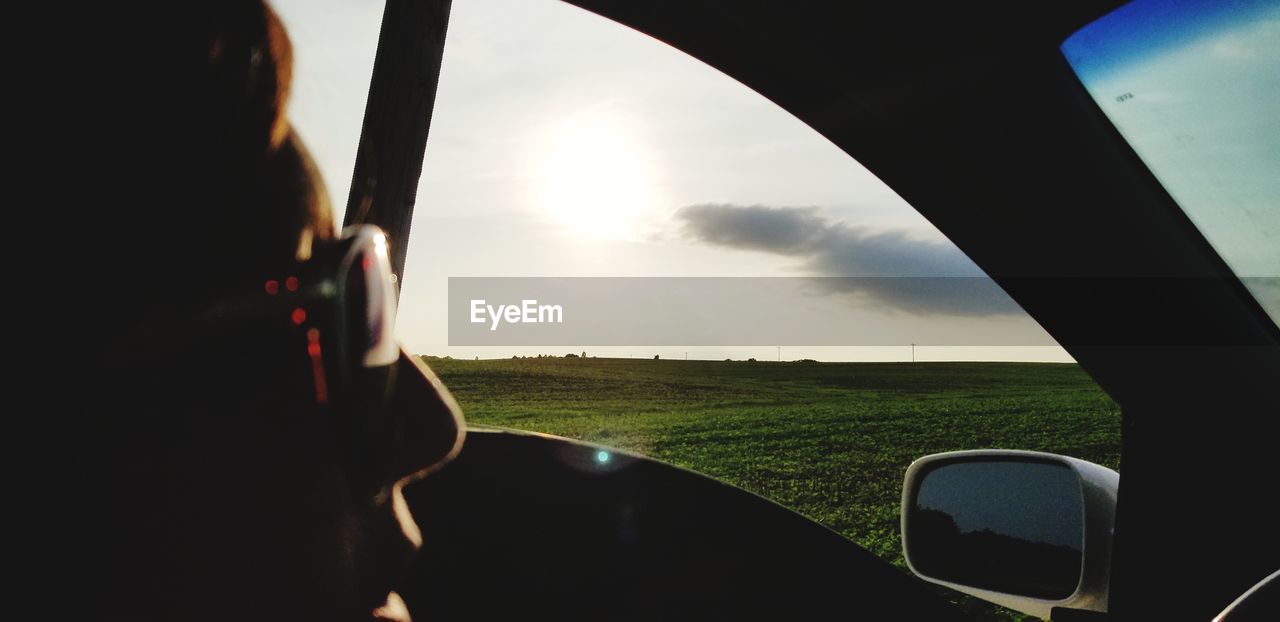 SCENIC VIEW OF FIELD SEEN THROUGH WINDSHIELD