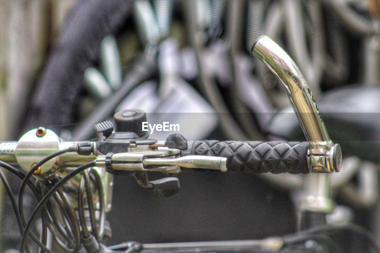 CLOSE-UP OF BICYCLE PARKED ON METAL