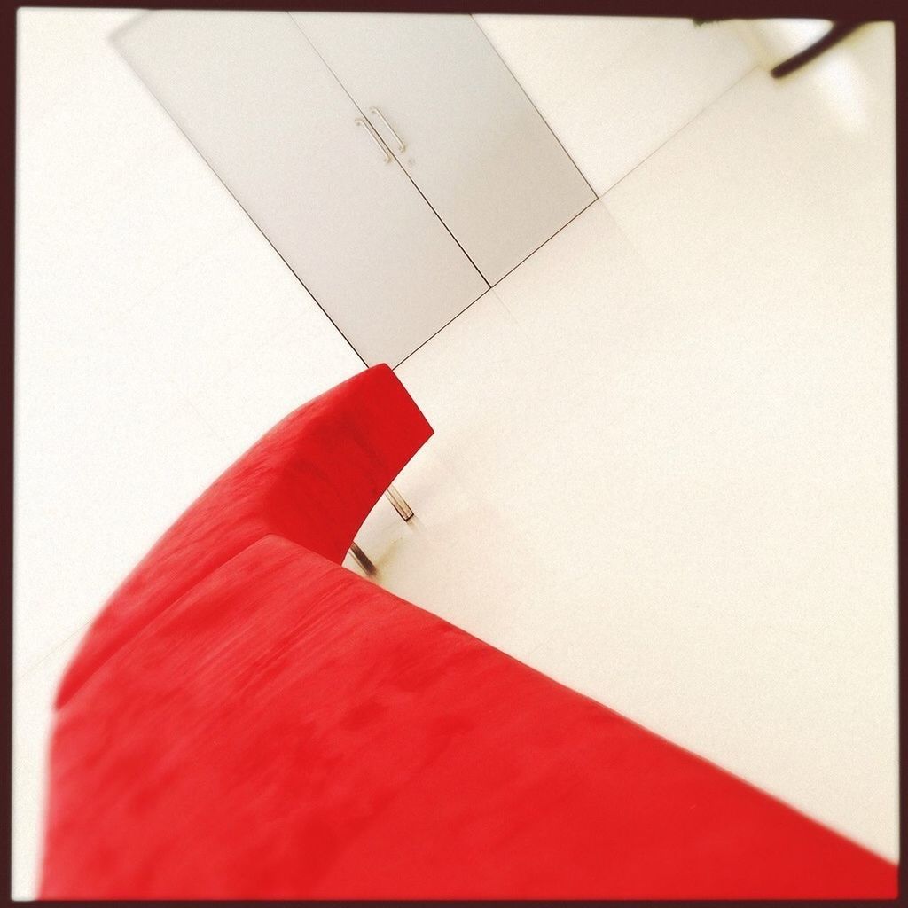 Close-up of red sofa by door