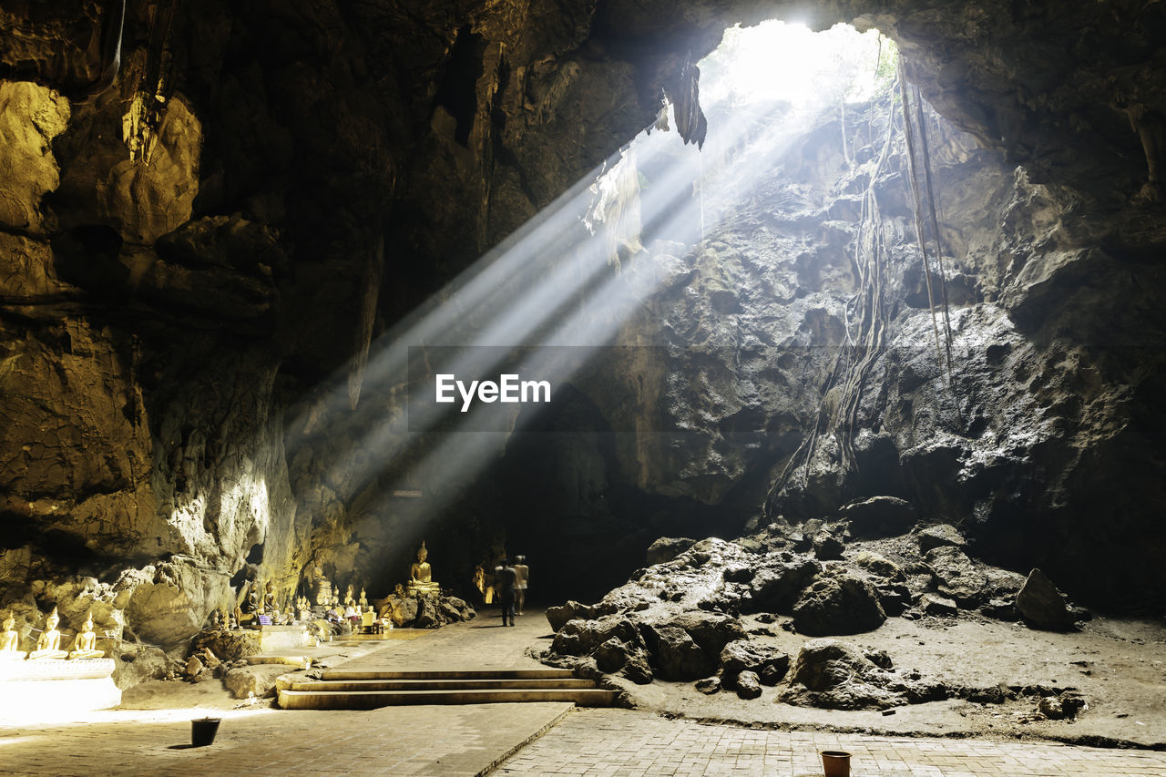 Sunlight streaming through rocks in cave