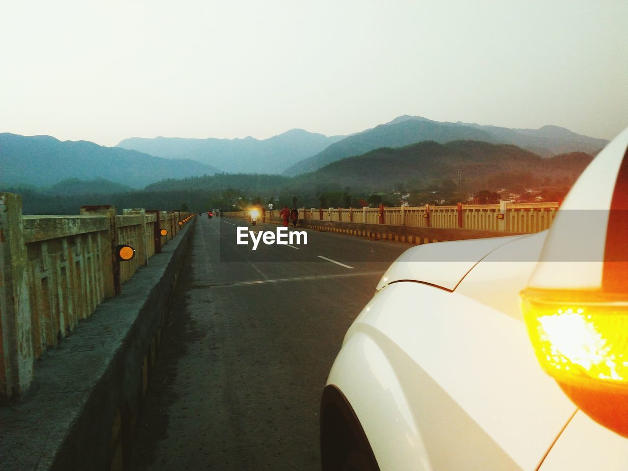 ROAD AMIDST MOUNTAINS AGAINST CLEAR SKY