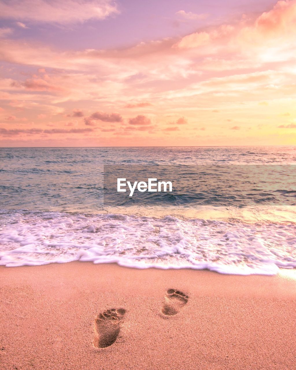 Scenic view of beach against sky during sunset