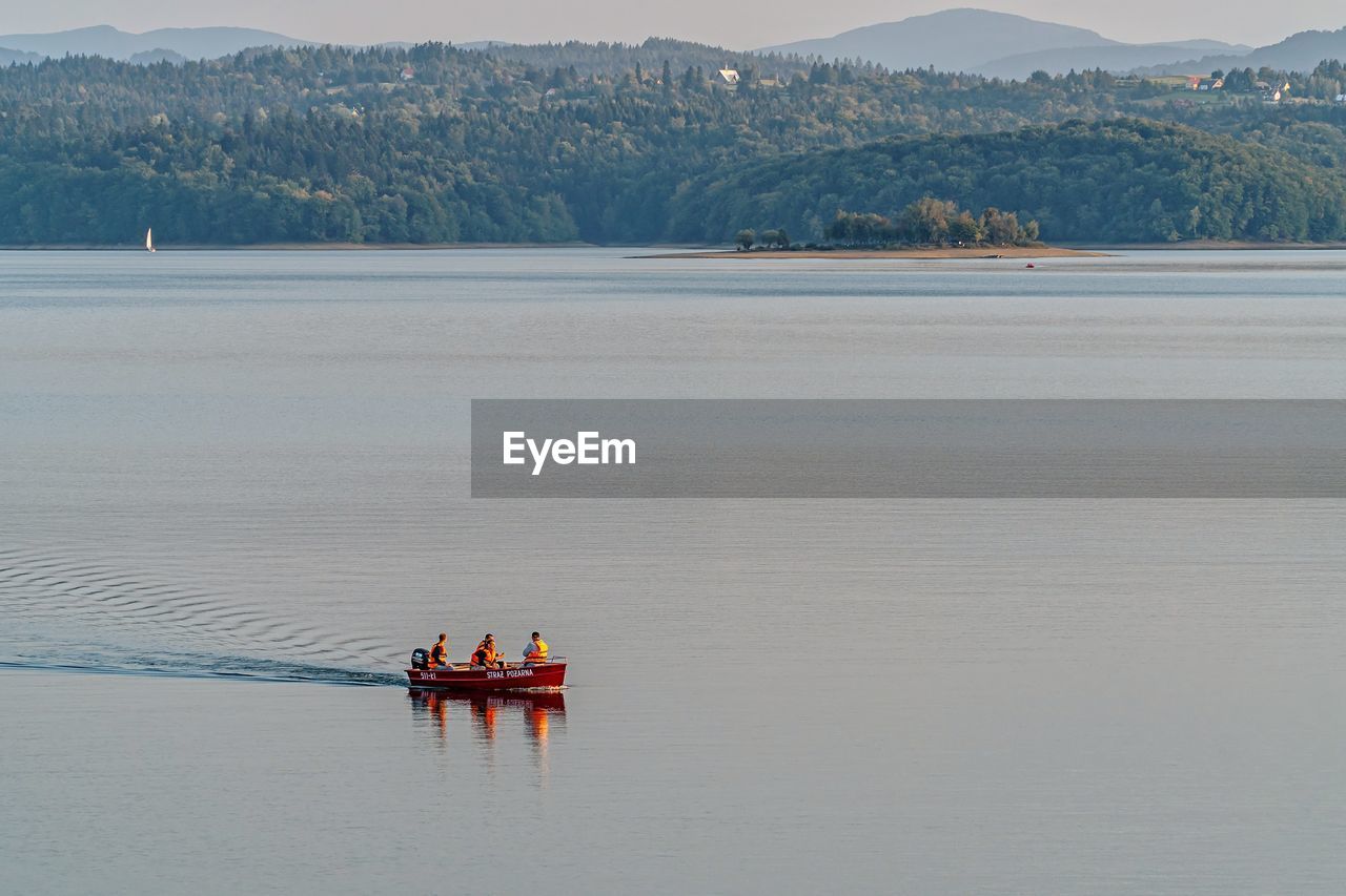 SCENIC VIEW OF LAKE BY MOUNTAINS