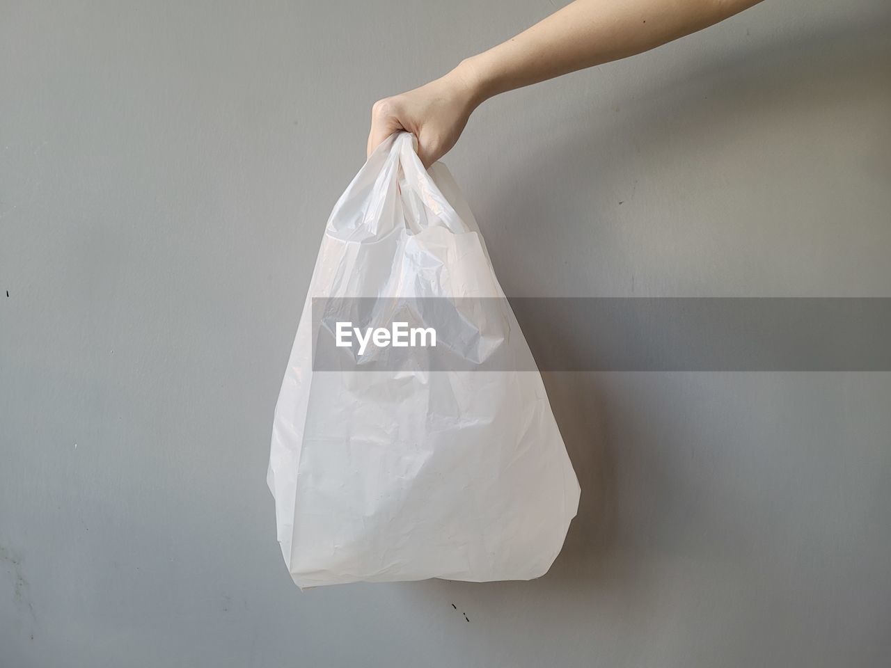 white, bag, handbag, plastic bag, indoors, hand, one person, studio shot, plastic, holding, shopping bag, adult, close-up, women, gray, copy space