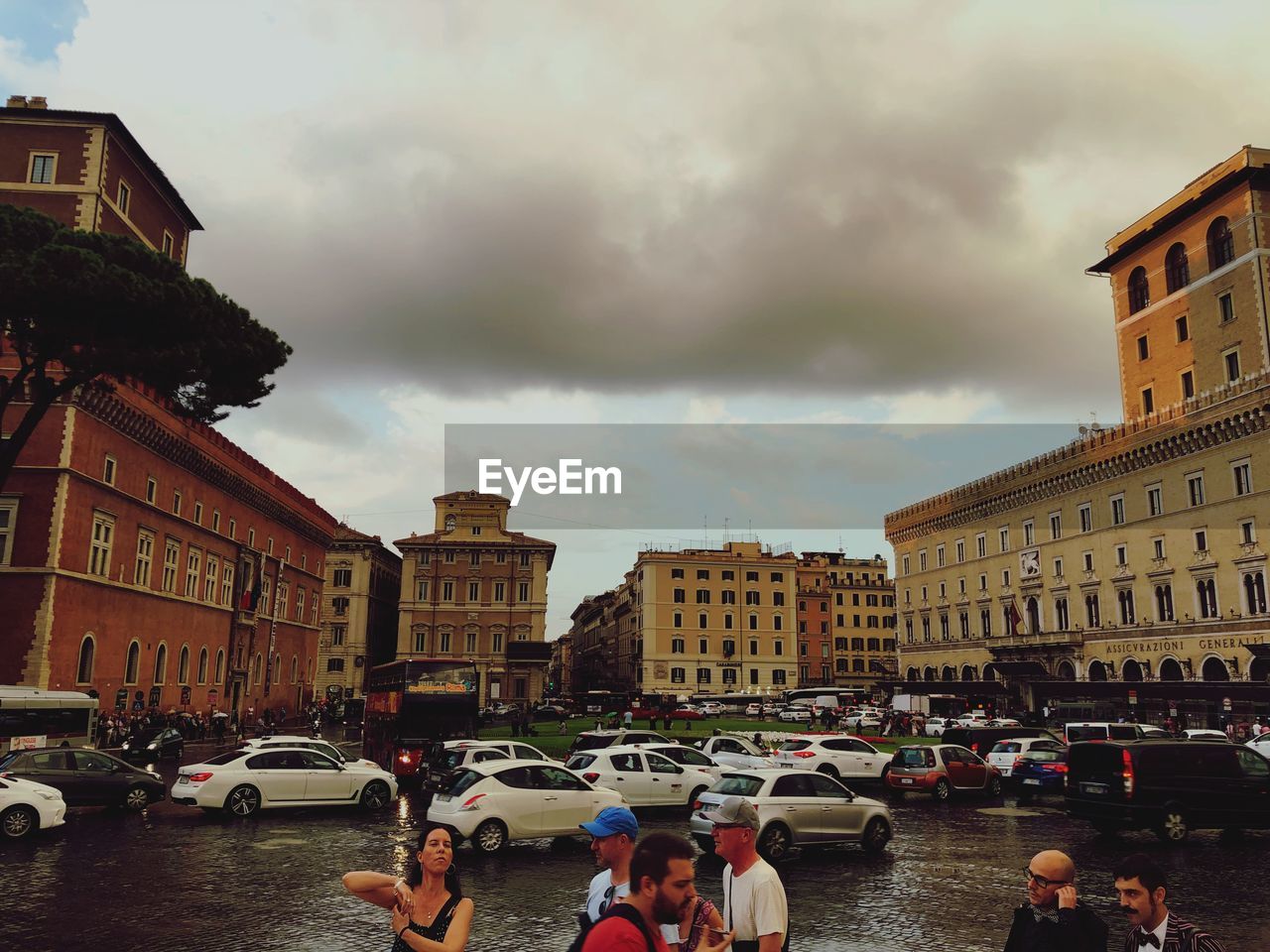 PEOPLE ON STREET BY BUILDINGS AGAINST SKY IN CITY