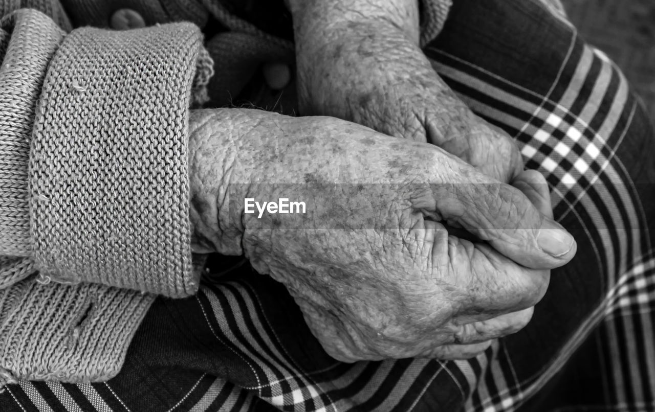 Midsection of senior woman with hands clasped