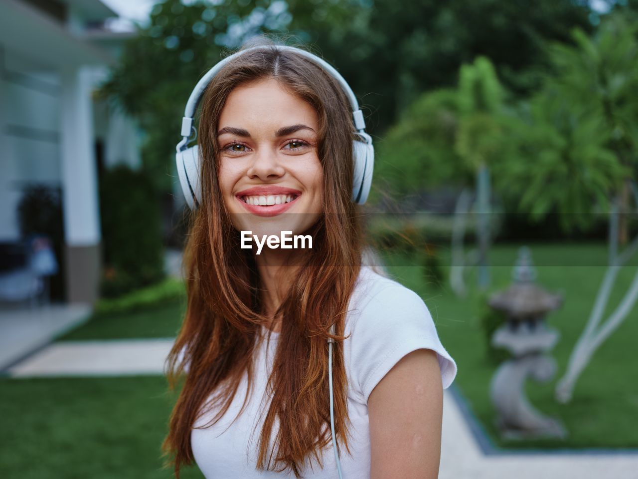 portrait of young woman looking away against trees
