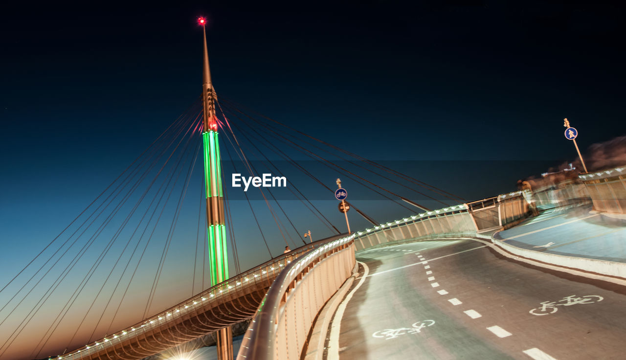 TRAFFIC ON BRIDGE AGAINST SKY AT NIGHT