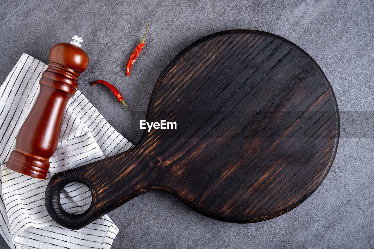 wood, string instrument, plucked string instruments, guitar, indoors, still life photography, no people, studio shot, still life, table, kitchen utensil, household equipment, high angle view, gray, close-up, directly above