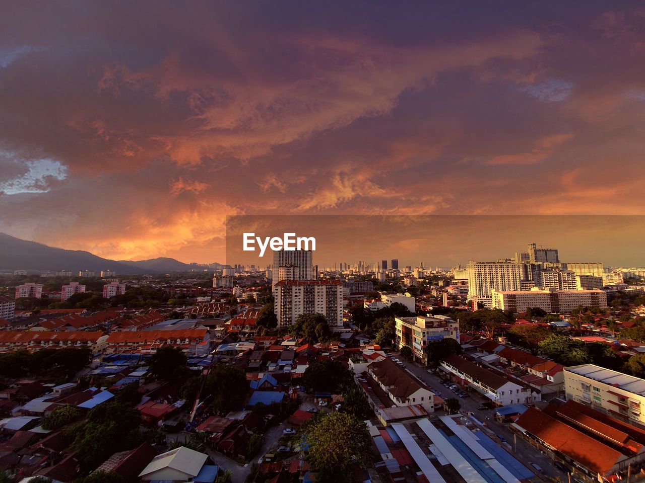 High angle view of city buildings against sky during sunset