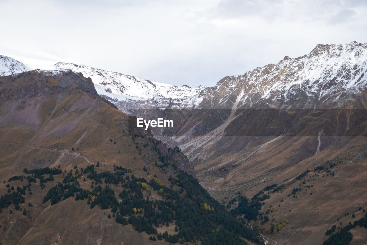 View from above on the slopes of the mountains, overgrown with forest in autumn. mountain. 