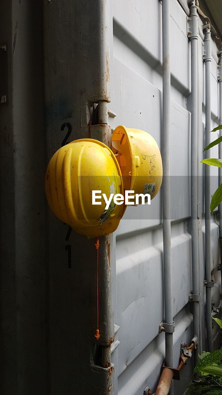 CLOSE-UP OF YELLOW PIPE ON WALL