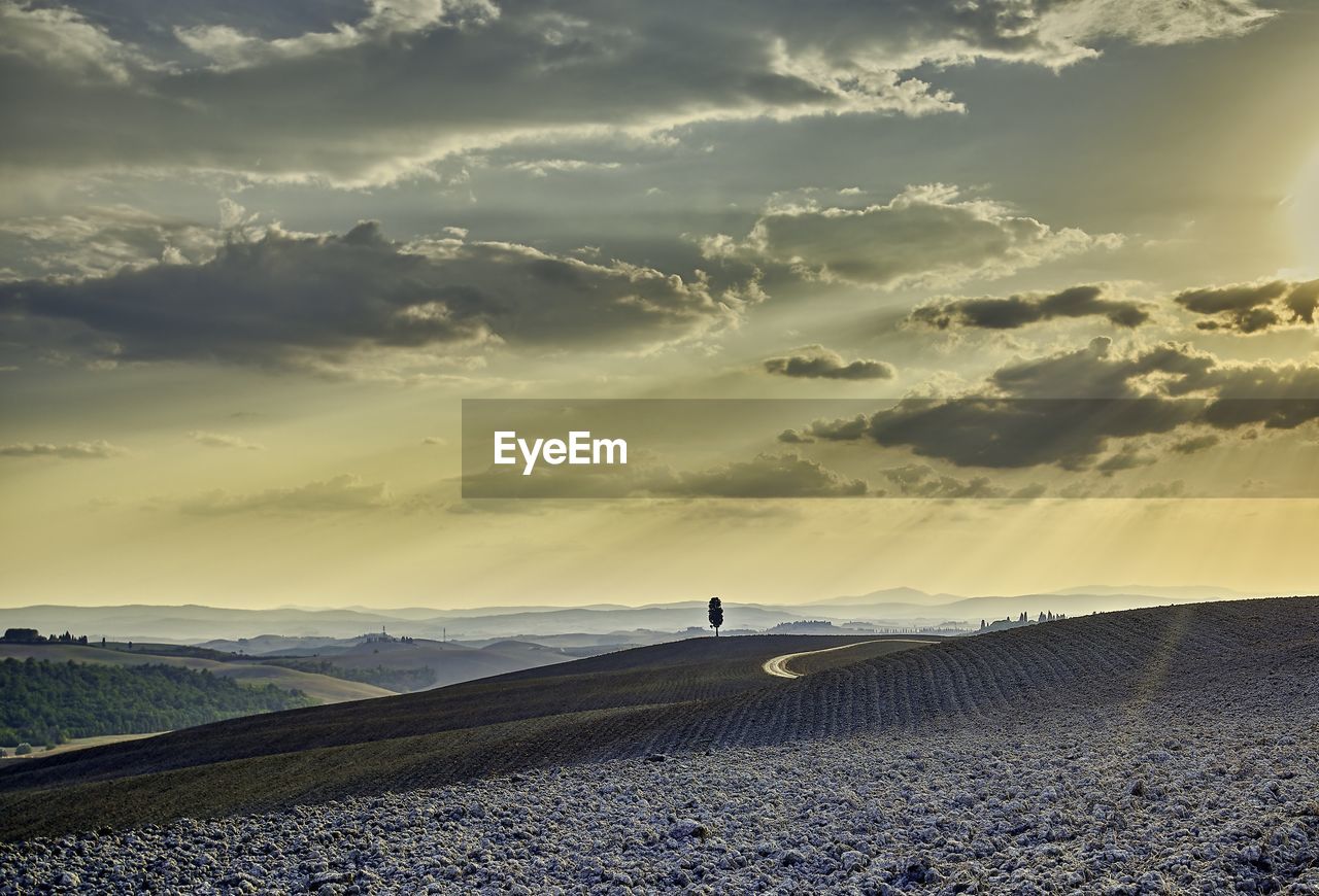 SCENIC VIEW OF LAND DURING SUNSET