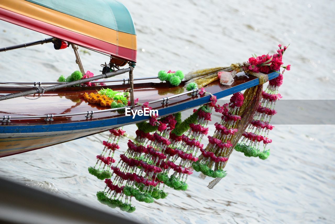 Cropped image of boat with flower decoration in lake