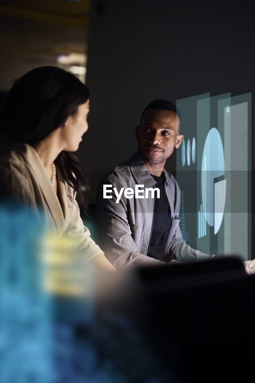 Two young business people working together in office