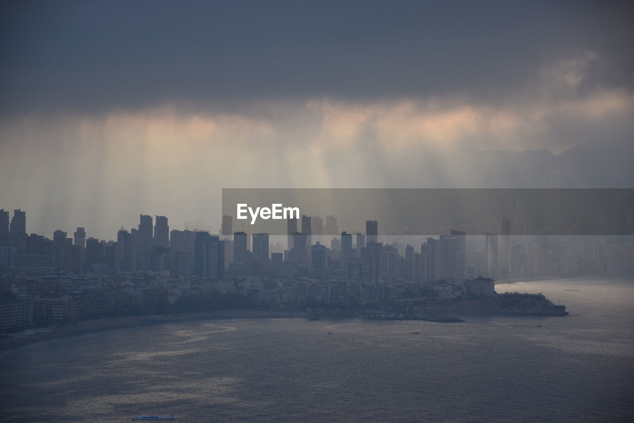 View of sea and buildings during stormy weather