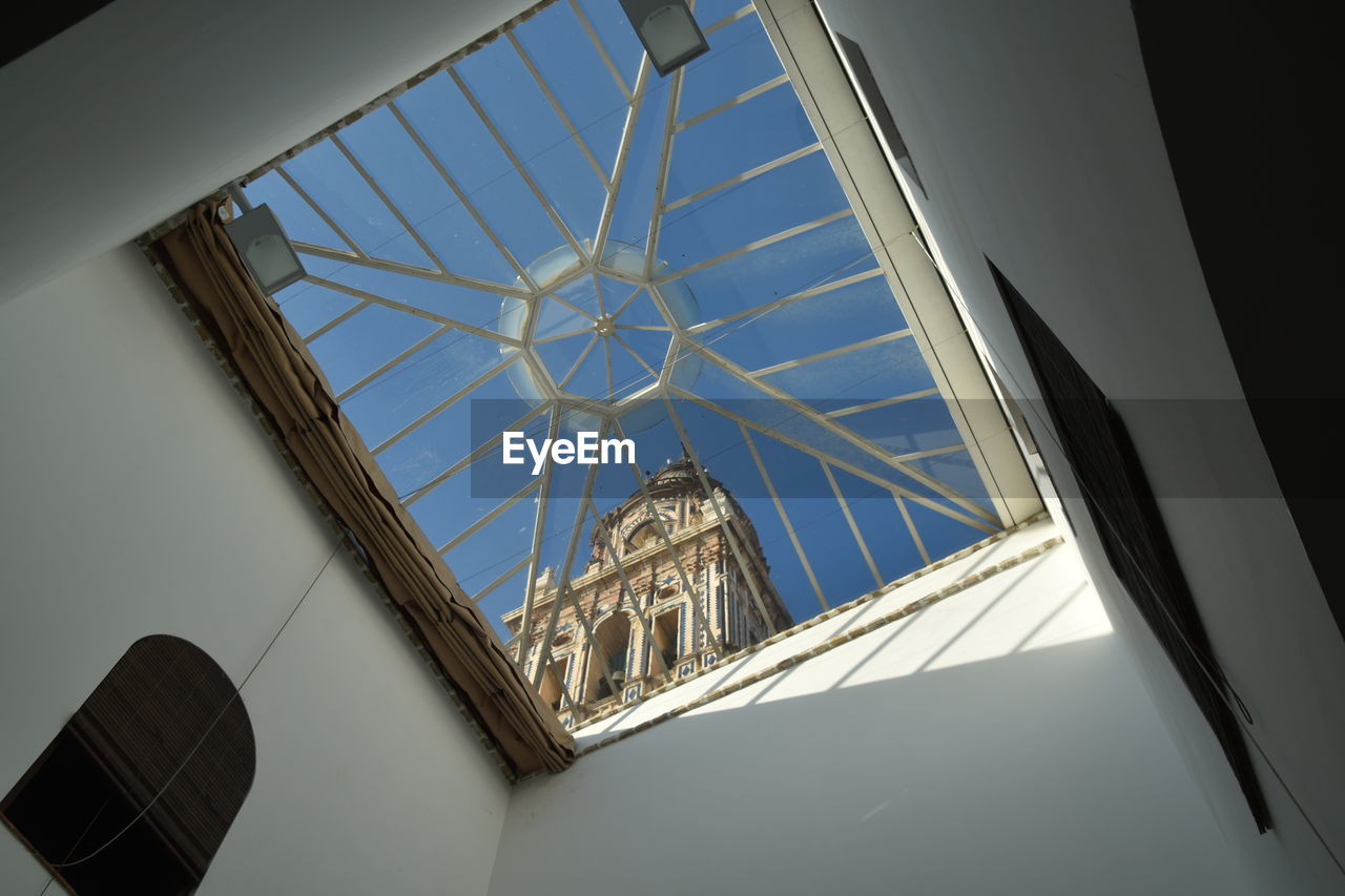 The bell tower through the glass ceiling
