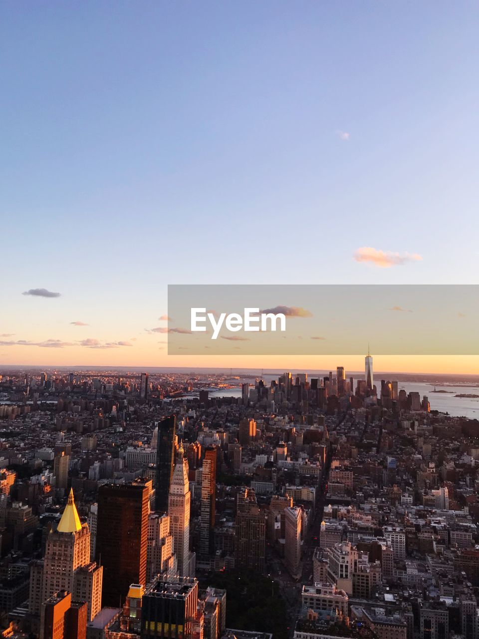 Aerial view of buildings in city during sunset